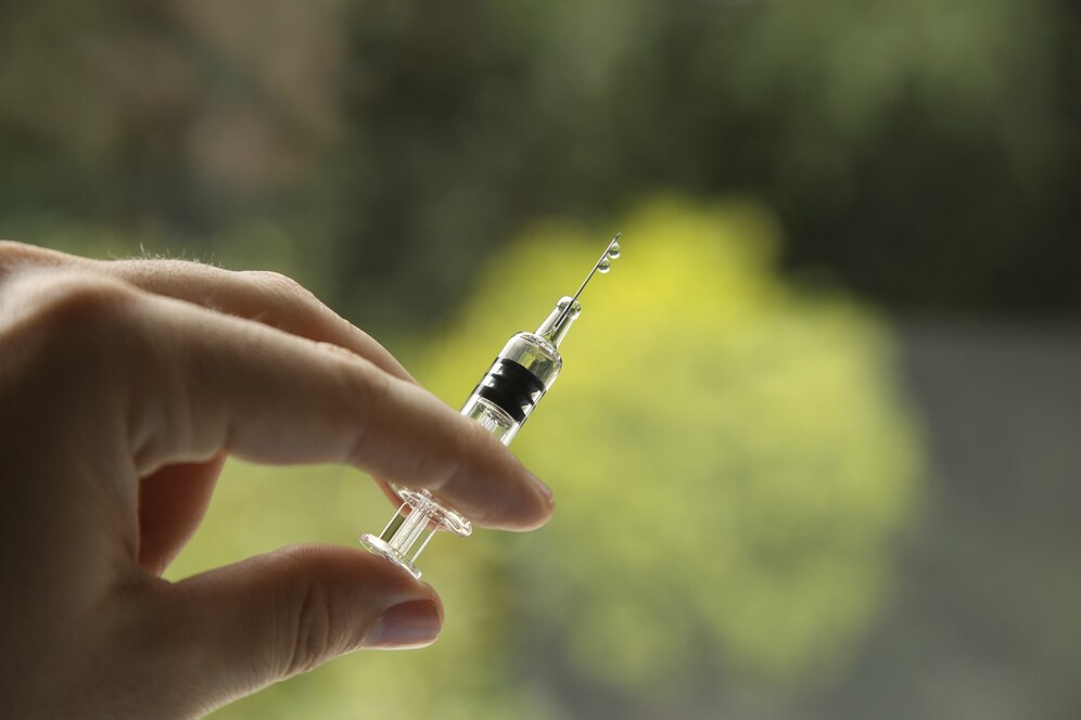 closeup view female holding syringe blurred background 181624 17927