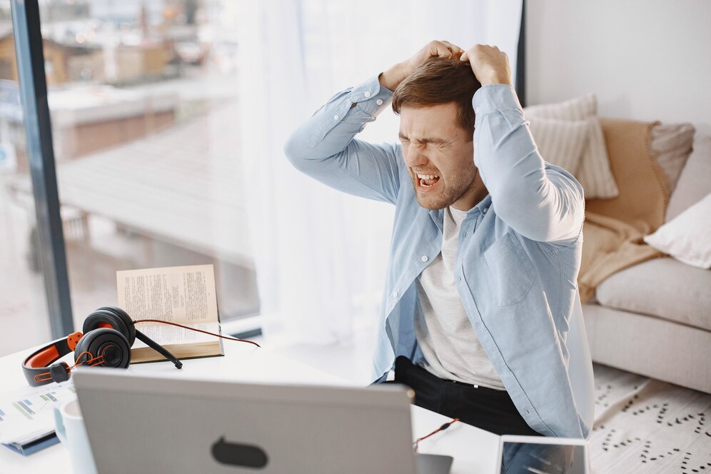 man sitting living room home guy enjoying studying using laptop headset angry 1157 48721