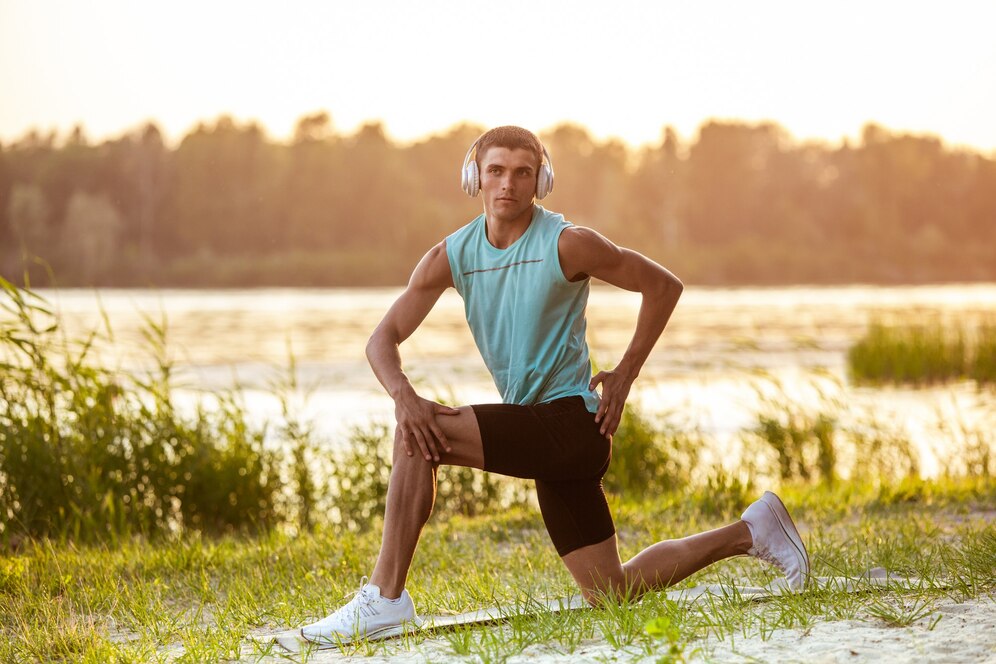 young athletic man working out listening music riverside outdoors 155003 41536